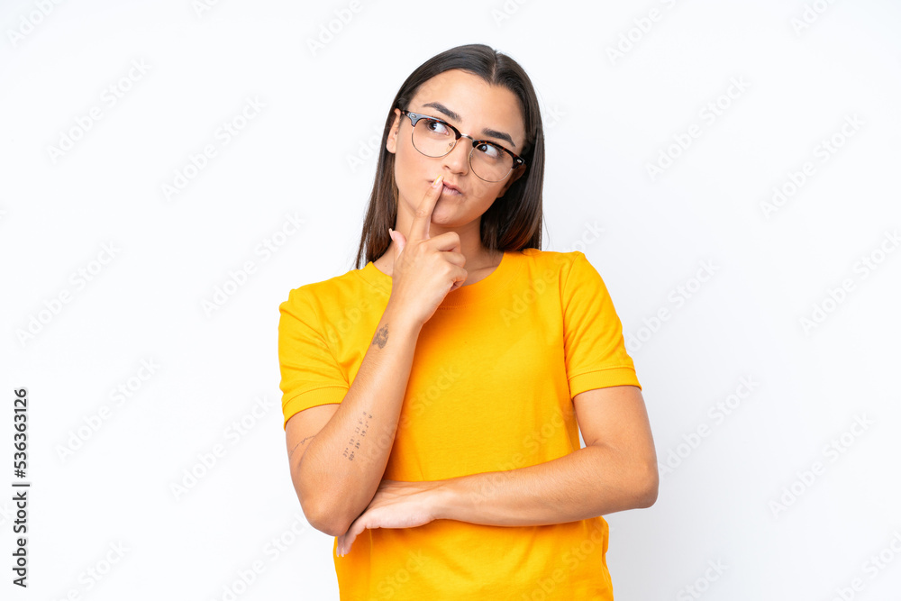 Young caucasian woman isolated on white background having doubts while looking up Young caucasian woman isolated on white background having doubts while looking up