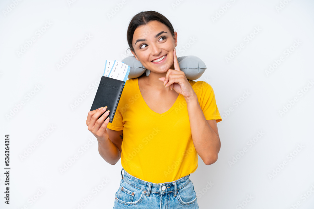 Woman with Inflatable Travel Pillow over isolated background thinking an idea while looking up Woman with Inflatable Travel Pillow over isolated background thinking an idea while looking up