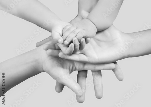 hands of parents and children and siblings together in black and white