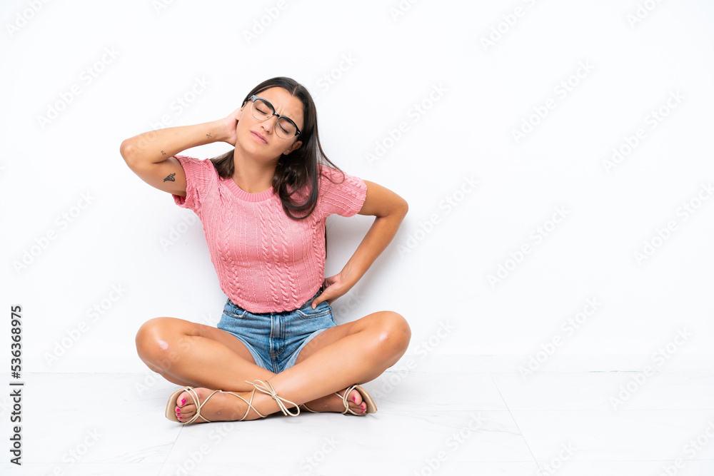Young caucasian woman sitting on the floor isolated on white background with neckache Young caucasian woman sitting on the floor isolated on white background with neckache