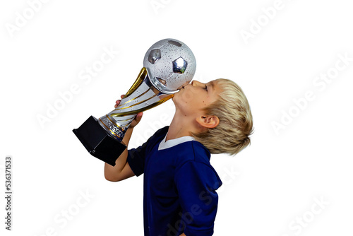 Young soccer player in blue jersey holds winners cup after the goal, isolated at light background