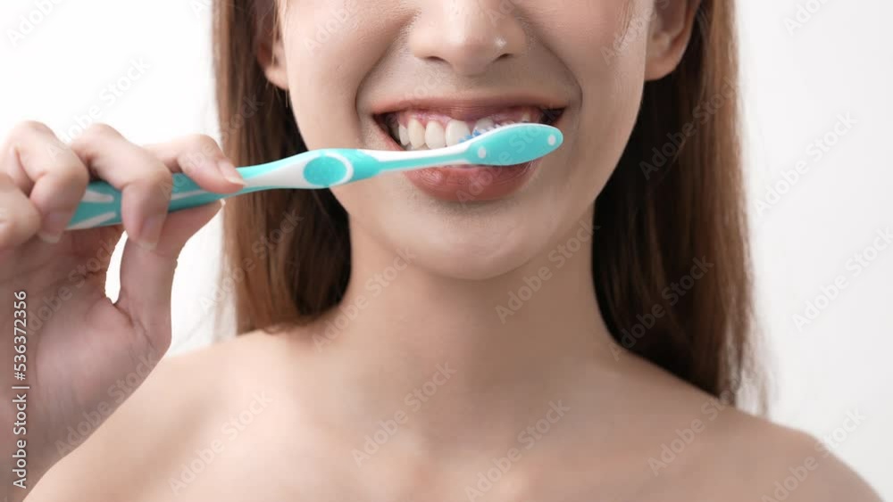 Beauty concept of 4k Resolution. Asian woman brushing teeth on a white background. Beauty concept of 4k Resolution. Asian woman brushing teeth on a white background.