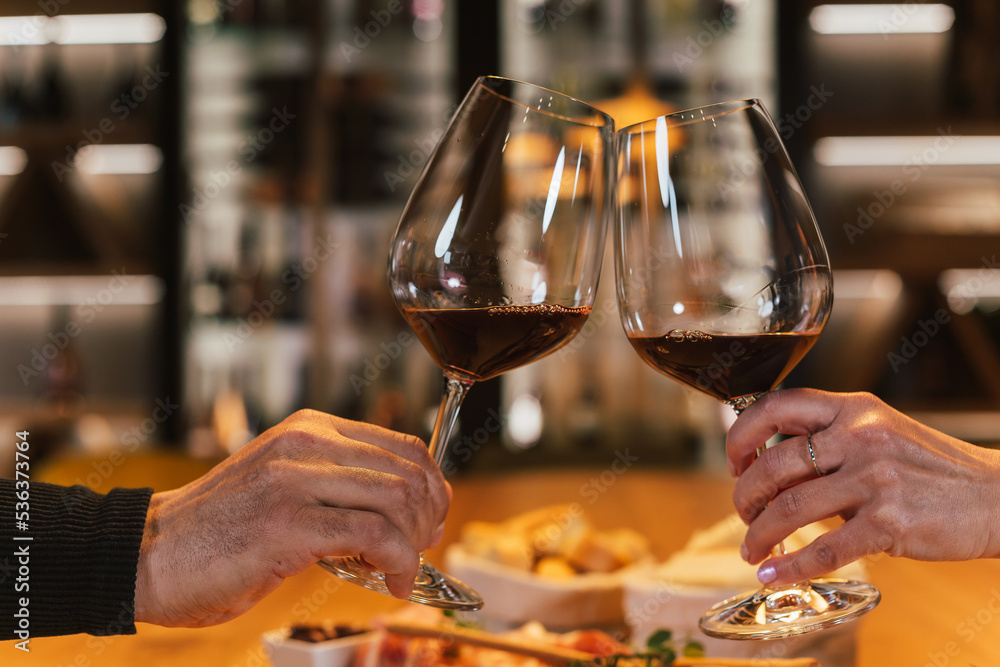 Romantic couple sitting opposite each other at the dining table in the