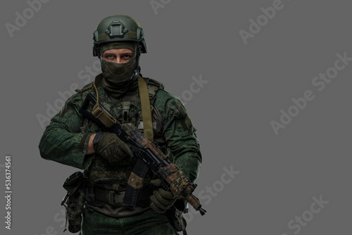 Shot of russian armed forces soldier dressed in camouflage uniform and holding rifle. photo