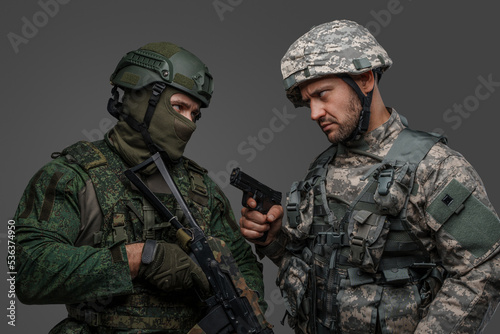 Photo of angry russia and nato soldiers and their confrontation against grey background.