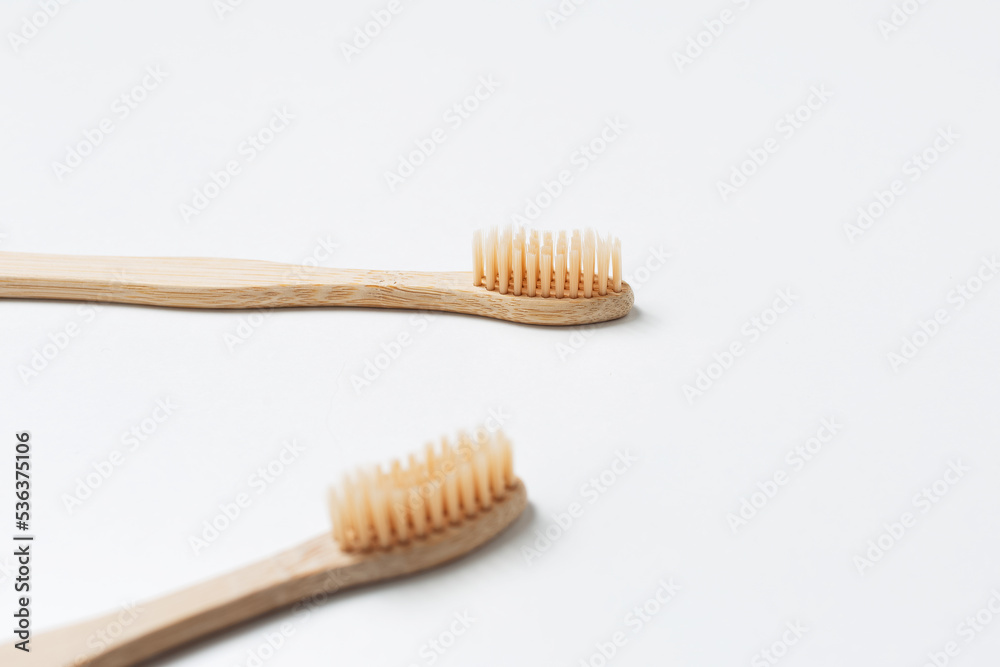 Close-up of two bamboo toothbrushes isolated on white background. Health care concept. Close-up of two bamboo toothbrushes isolated on white background. Health care concept.