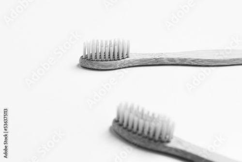 Close-up of two bamboo toothbrushes isolated on white background. Black and white photo.