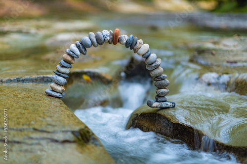 Fotografía Arc crookedness of the pebbles on crystal clear river