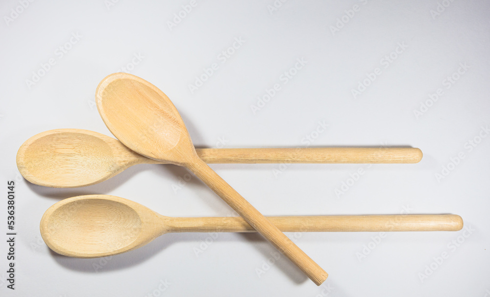 Closeup and top view of three wooden spoons isolated on white background. Closeup and top view of three wooden spoons isolated on white background.