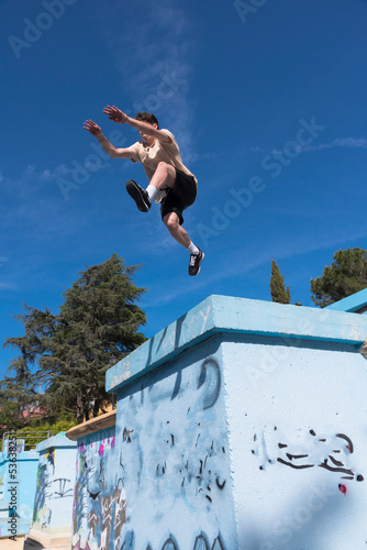 young guy doing parkour in the urban area