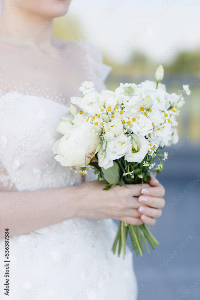 wedding bouquet in the hands of the bride wedding bouquet in the hands of the bride