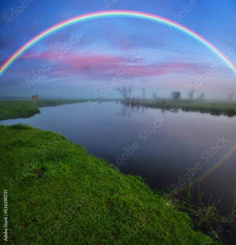 Landscape with a Rainbow on the River in Spring. colorful morning. nature of Ukraine