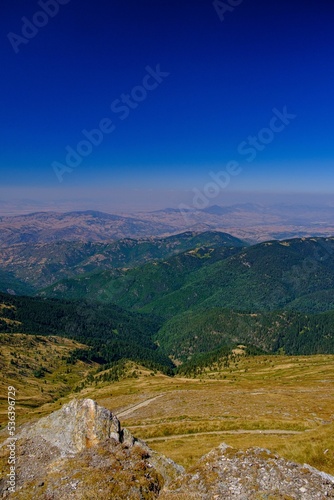 Vertical shot of a vivid bright landscape of green Kaimakchalan mountain photo