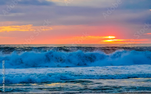 Colorful golden sunset big wave and beach Puerto Escondido Mexico. © arkadijschell