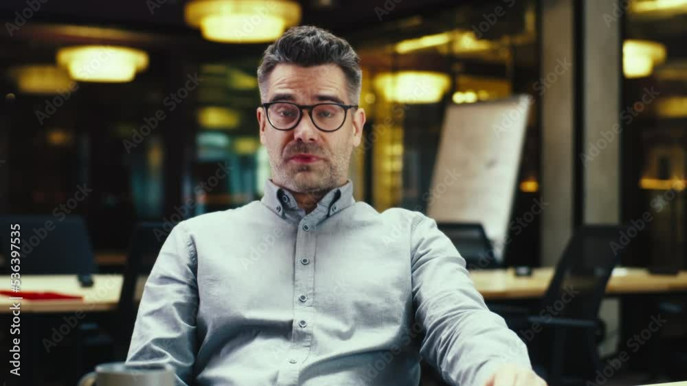 Portrait of male worker talking online with client, having video call, working in modern office of marketing company, looking at camera. Online business meeting. Computer screen view. Webcam view Portrait of male worker talking online with client, having video call, working in modern office of marketing company, looking at camera. Online business meeting. Computer screen view. Webcam view