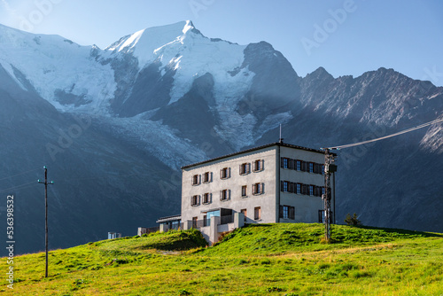 Hotel in Mont-Blanc massif. This hotel is located near Chamonix, in the french Alps. In the back, Aiguille de Bionnassay and the Bionnassay Glacier can be seen. photo
