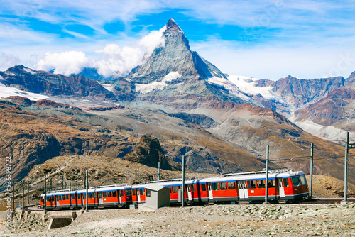 Gornergrat Bahn going up to the Gornergrat train station near Zermatt. Matterhorn peak (also called Cervino or Cervin) is seen in the background. photo
