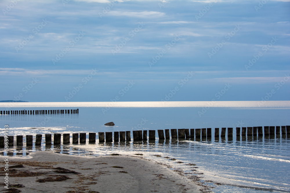 Breakwater in the calm sea with blue sky