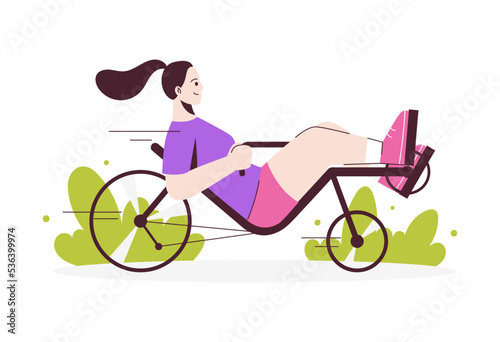 Girl rides recumbent bicycle. Active lifestyle concept.