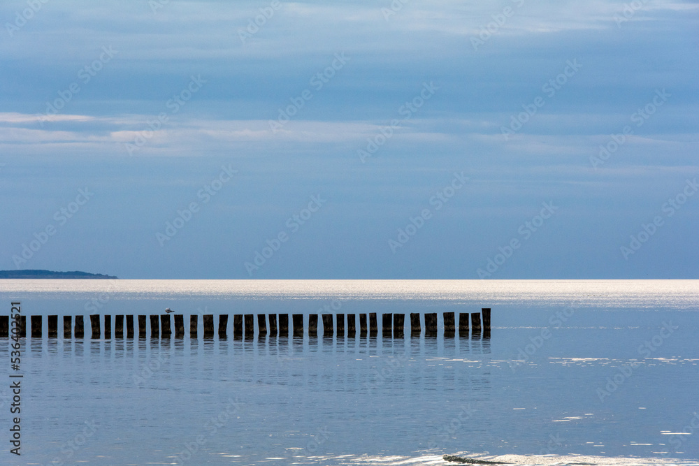 Breakwater in the calm sea with blue sky