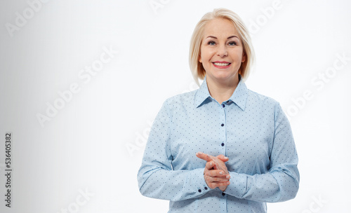 Photos Middle aged businesswoman with folded arms on grey background