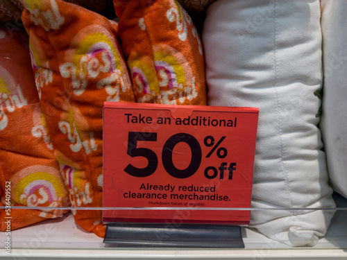 Sign offering customers 50 percent off already reduced clearance merchandise photo