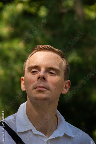 Young man having fun on a walk in the park