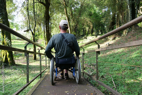 Paraplegic using ramp made for wheelchair users in park