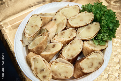 delicious pancakes with potatoes and herbs on a white plate