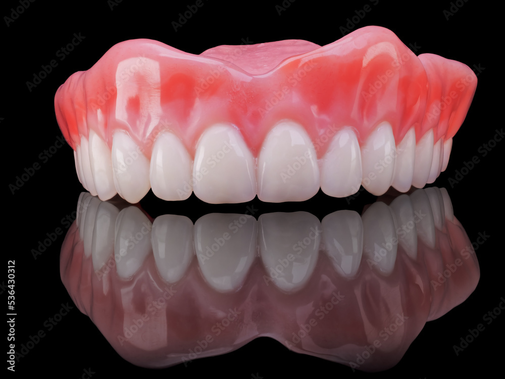 Obraz premium removable upper denture on black glass background