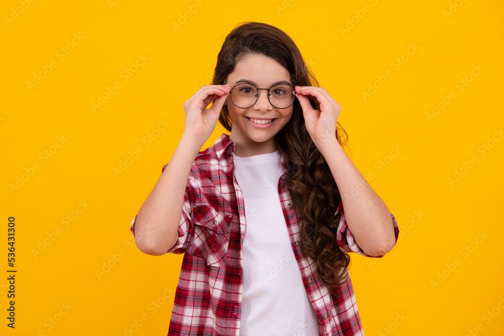 Teenager child wearing glasses on yellow studio background. Cute girl in eyeglasses. Happy teenager, positive and smiling emotions of teen girl. Teenager child wearing glasses on yellow studio background. Cute girl in eyeglasses. Happy teenager, positive and smiling emotions of teen girl.