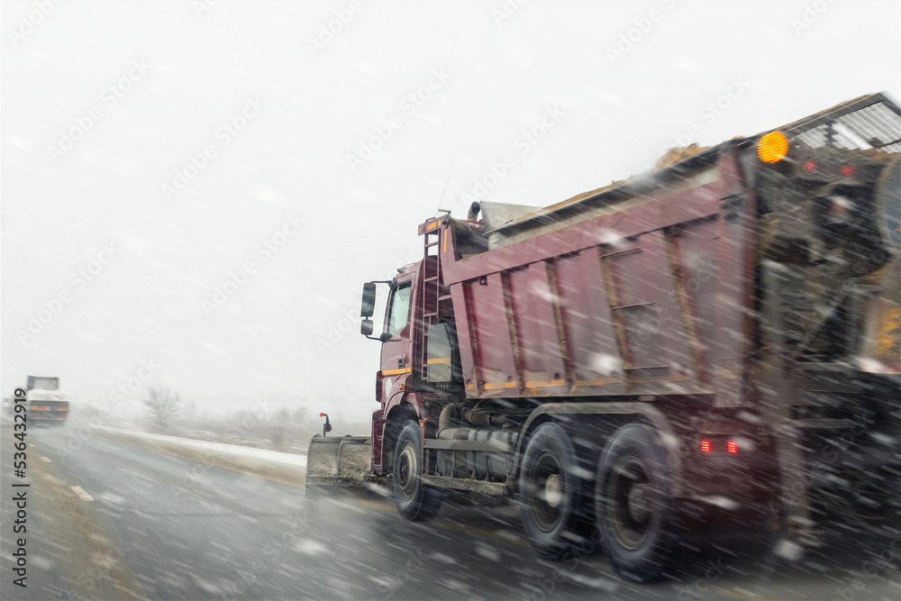 Snowplow truck removing dirty snow from city street or highway after heavy snowfalls. Traffic road situation. Weather forecast for drivers. Seasonal road maintenance. Bad conditions, slippery freeway