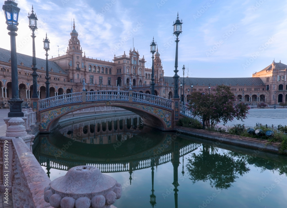 View of Seville Andalusia Spain square with ceramic bridge in canal and architectural background 