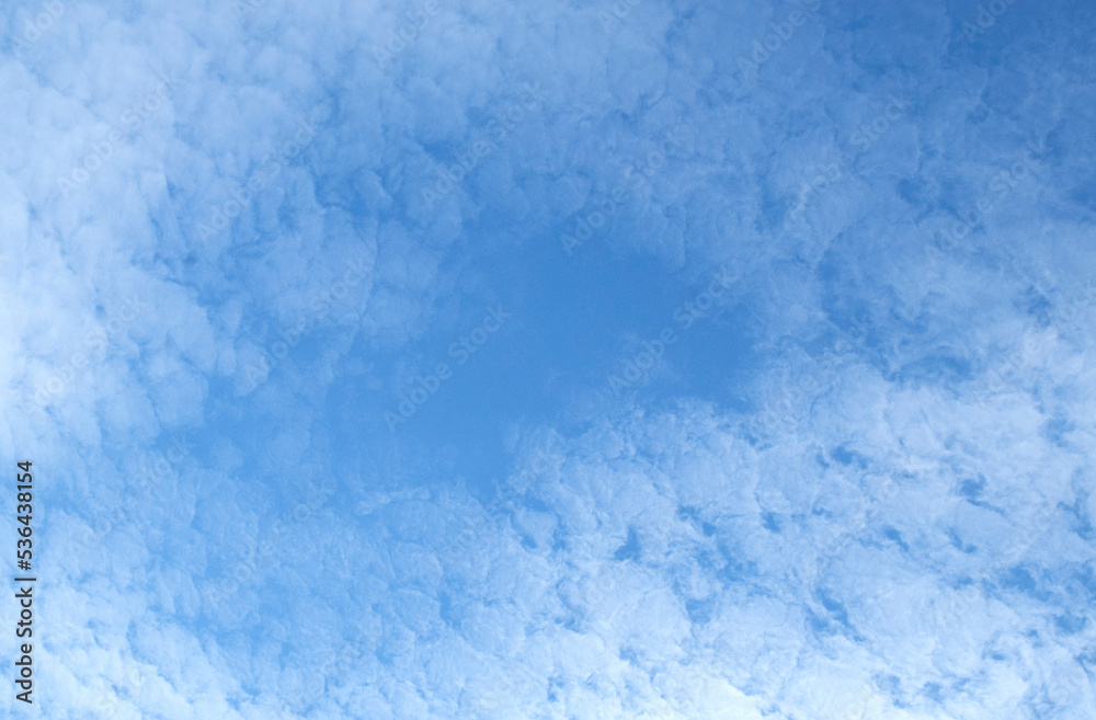 Gentle white clouds in a bright blue sky Gentle white clouds in a bright blue sky
