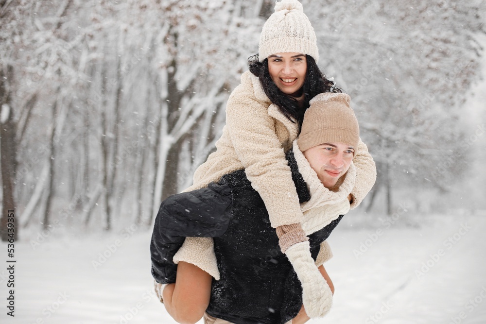 Obraz premium Romantic couple walking in forest at winter day
