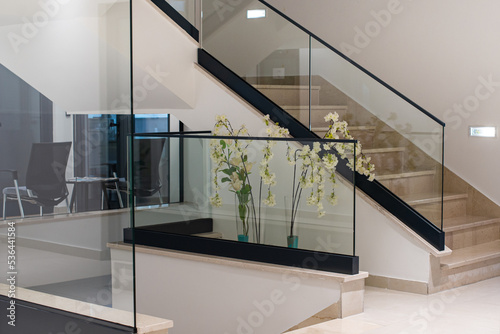 white interior with glass fence and stairs