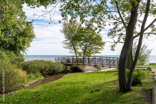 A footbridge crosses a small stream flowing into Lake Erie in the former pioneer town of Normandale, Ontario, now primarily a cottage town.
