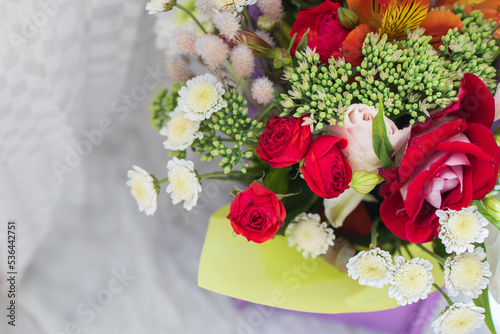 beautiful bright bouquet in a purple basket on a white background, copy space