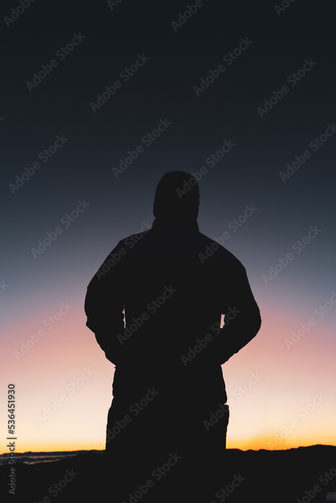 silhouette of a person watching the sunrise
