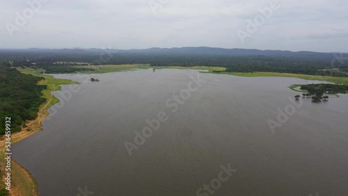 Aerial drone of Tropical landscape with lake, jungle and mountains. Kantale tank, Sri Lanka. photo