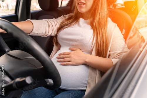 Pregnancy driving car. Young beautiful pregnant woman driving car. Safety pregnancy, mother health care concept. © Maksym
