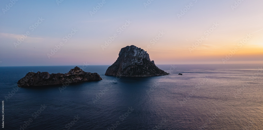 Aerial view of Es Vedra Ibiza during sunset. Showing ocean and clear skies.