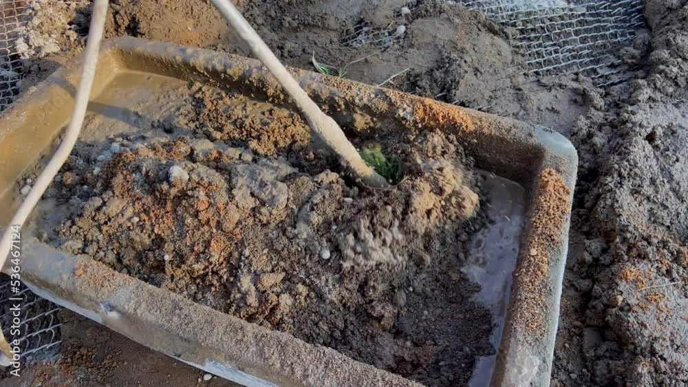 Mixing mortar with a mixer. Cement mortar mix. Mortar consists of a mix