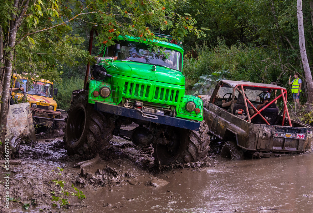 The car overcomes difficult obstacles. Large-scale sports competitions of off-road cars The car overcomes difficult obstacles. Large-scale sports competitions of off-road cars