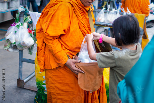 Thai monk ask for alms for buddhist to make merit photo