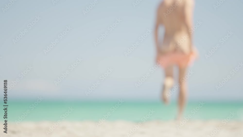 Unrecognizable man running into the sea naked