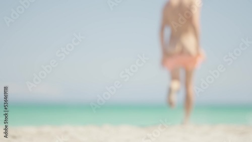 Unrecognizable man running into the sea naked
