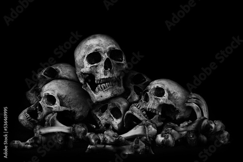Awesome pile of skull human and bone on black cloth background, concept of scary crime scene of horror or thriller movies,Halloween theme, Still Life style, selective focus,