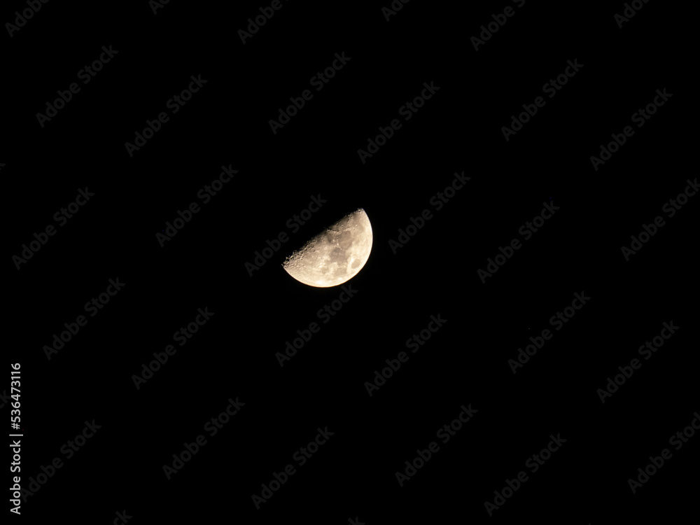 Time lapse of moon at night with a copy space. Half moon with detail surface. Time lapse of moon at night with a copy space. Half moon with detail surface.