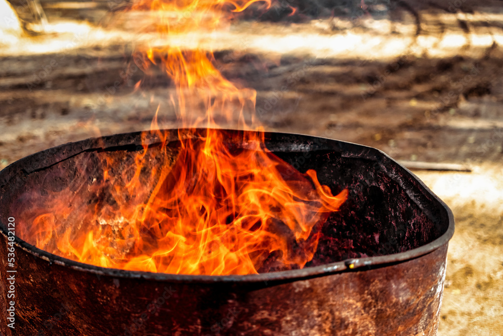 Burning fire in a barrel close-up. Bright flame. Open flame heating. Problems with heating and gas. Burning fire in a barrel close-up. Bright flame. Open flame heating. Problems with heating and gas.